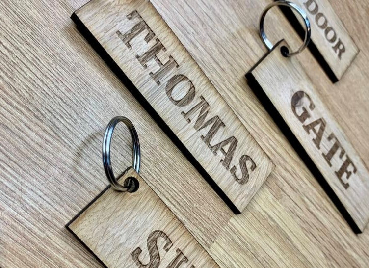 Rectangular key rings with serif style font, with your choice of word. A hole in the corner with a split ring. Oiled for extra protection.